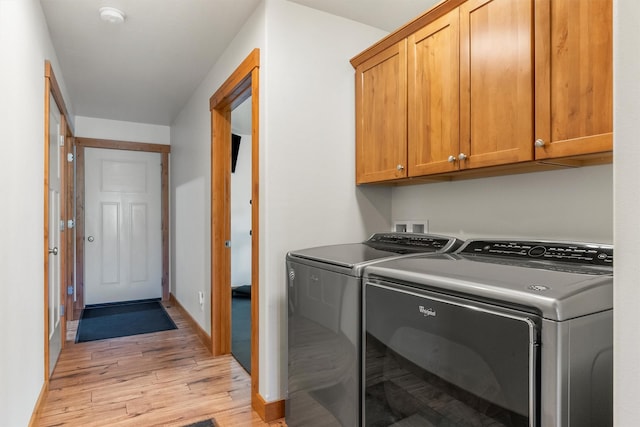999 Websters Way, Stevensville, MT 59870 - clothes washing area featuring independent washer and dryer, light wood-style flooring, cabinet space, and baseboards