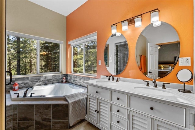 141 Aspen Ln, Eureka, MT 59917 - full bathroom featuring healthy amount of natural light, double vanity, and a whirlpool tub