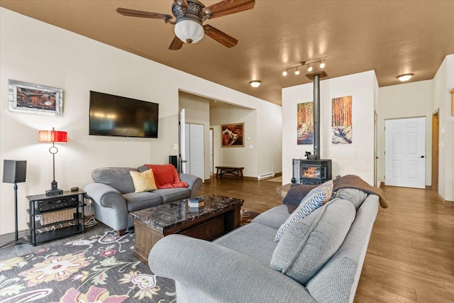 141 Aspen Ln, Eureka, MT 59917 - living room featuring a wood stove, ceiling fan, and wood finished floors