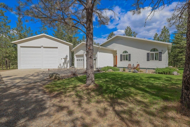 141 Aspen Ln, Eureka, MT 59917 - single story home featuring a front yard, a detached garage, and an outbuilding