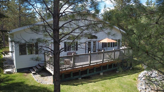 141 Aspen Ln, Eureka, MT 59917 - rear view of house featuring a wooden deck and a lawn