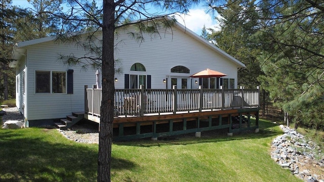141 Aspen Ln, Eureka, MT 59917 - rear view of house with a lawn and a wooden deck