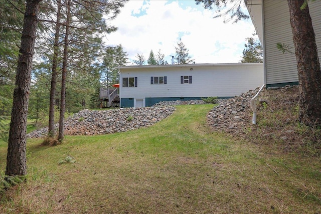 141 Aspen Ln, Eureka, MT 59917 - rear view of house with stairway, a lawn, and a deck