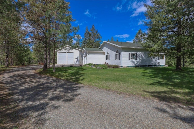 141 Aspen Ln, Eureka, MT 59917 - view of side of home featuring driveway, a yard, and an attached garage