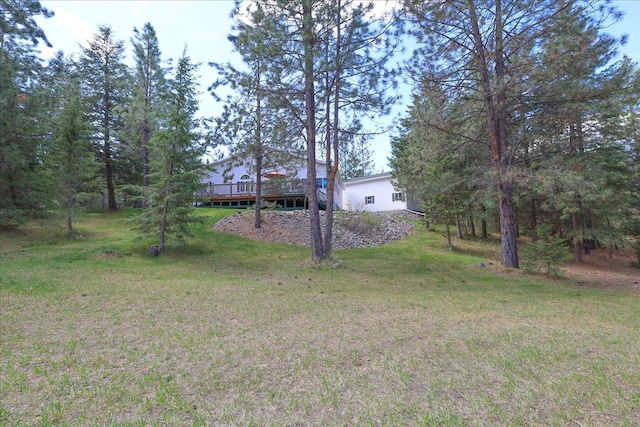 141 Aspen Ln, Eureka, MT 59917 - view of green lawn with a wooden deck