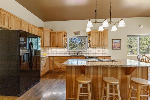 141 Aspen Ln, Eureka, MT 59917 - kitchen with black appliances, open shelves, dark wood-type flooring, a center island, and decorative backsplash