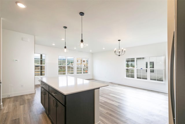 NHNLOT1 England Blvd, Missoula, MT 59808 - kitchen with light wood-style floors, light countertops, a chandelier, pendant lighting, and a kitchen island