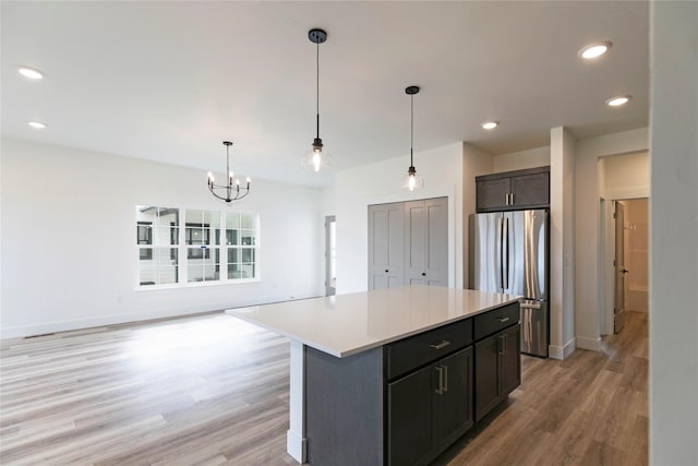 NHNLOT1 England Blvd, Missoula, MT 59808 - kitchen featuring freestanding refrigerator, light wood-type flooring, a chandelier, light countertops, and hanging light fixtures
