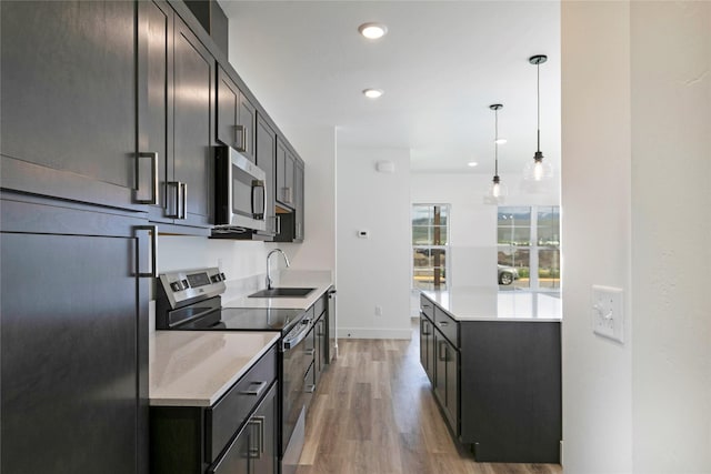 NHNLOT1 England Blvd, Missoula, MT 59808 - kitchen featuring appliances with stainless steel finishes, light wood-style flooring, light countertops, recessed lighting, and hanging light fixtures