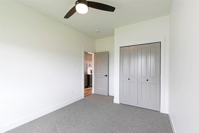 NHNLOT1 England Blvd, Missoula, MT 59808 - unfurnished bedroom featuring carpet, a closet, and a ceiling fan