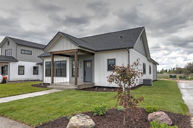 NHNLOT1 England Blvd, Missoula, MT 59808 - modern farmhouse style home featuring board and batten siding, a front yard, roof with shingles, and a porch