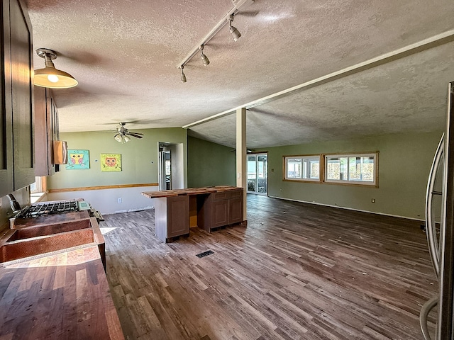 485 Wilson Butte Rd, Great Falls, MT 59405 - kitchen featuring open floor plan, wooden counters, dark wood-style floors, track lighting, and a textured ceiling