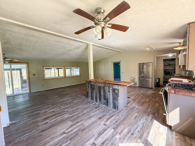 485 Wilson Butte Rd, Great Falls, MT 59405 - kitchen featuring stainless steel fridge, ceiling fan, butcher block countertops, a textured ceiling, and dark wood-type flooring