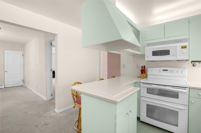 3313 5th Ave N, Great Falls, MT 59401 - kitchen featuring white appliances, green cabinetry, a peninsula, light colored carpet, and baseboards