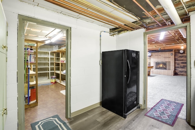 3313 5th Ave N, Great Falls, MT 59401 - unfinished below grade area with freestanding refrigerator, a brick fireplace, and wood finished floors