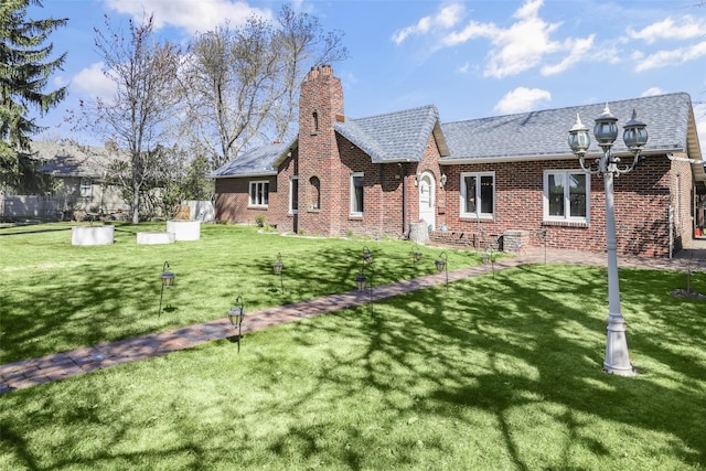 3313 5th Ave N, Great Falls, MT 59401 - rear view of house with brick siding, a lawn, a chimney, and roof with shingles