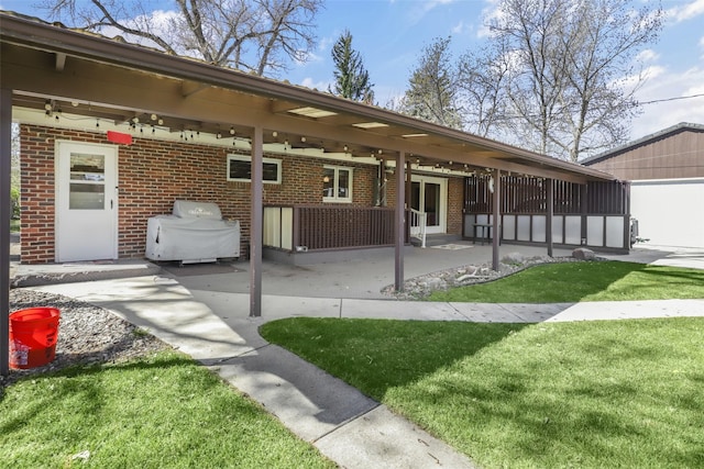 3313 5th Ave N, Great Falls, MT 59401 - exterior space with brick siding, a patio, a lawn, and french doors