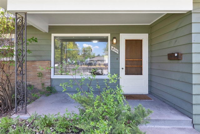 view of exterior entry with a porch