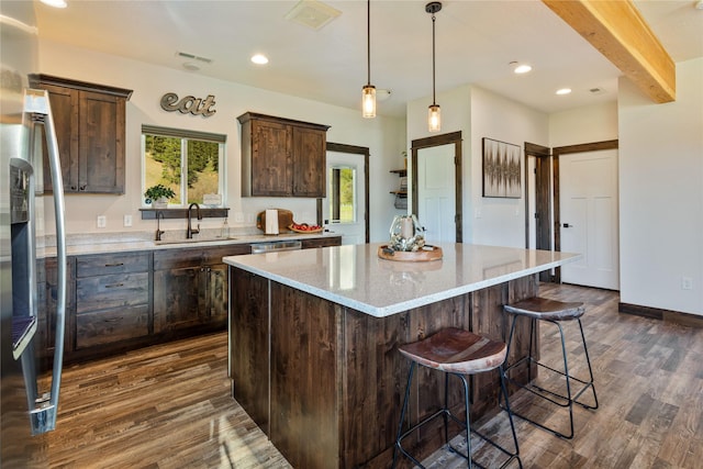 kitchen with a sink, dark brown cabinetry, freestanding refrigerator, dark wood-style floors, and recessed lighting