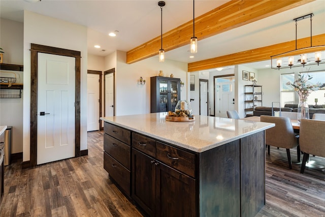 21087 Pamin Loop, Clinton, MT 59825 - kitchen featuring dark wood-style flooring, recessed lighting, beamed ceiling, dark brown cabinets, and light stone countertops