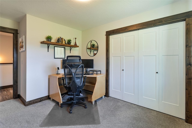 carpeted office space featuring baseboards
