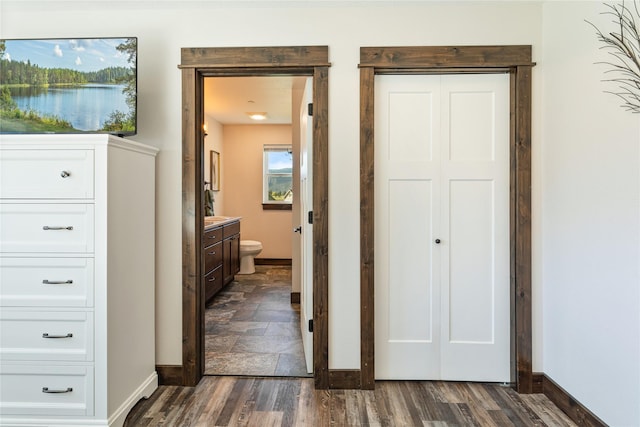 21087 Pamin Loop, Clinton, MT 59825 - unfurnished bedroom with a closet, connected bathroom, and dark wood-type flooring