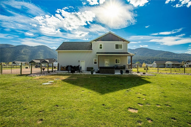 21087 Pamin Loop, Clinton, MT 59825 - back of house featuring a mountain view, a patio, and a hot tub