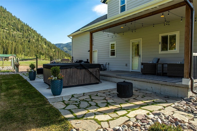 21087 Pamin Loop, Clinton, MT 59825 - view of patio with a hot tub and a mountain view