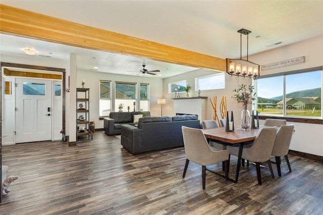 21087 Pamin Loop, Clinton, MT 59825 - dining room with dark wood finished floors, a chandelier, and ceiling fan