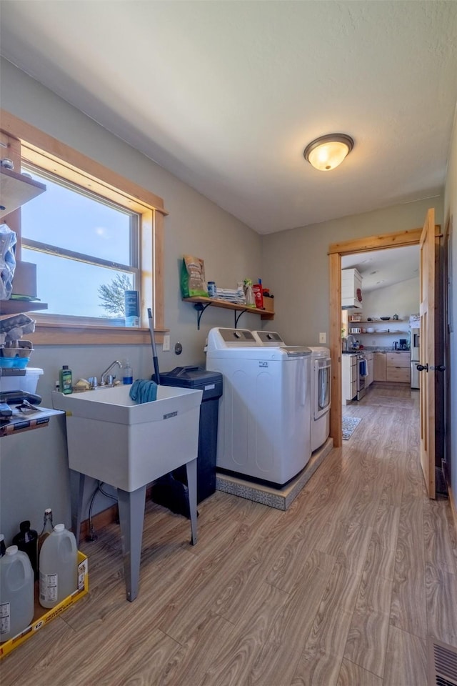 4175 Mchugh Ln, Helena, MT 59602 - clothes washing area with wood finished floors and washer and clothes dryer