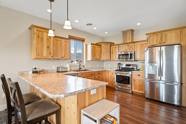 1317 Creekside Dr, Stevensville, MT 59870 - kitchen featuring stainless steel appliances, a sink, a peninsula, light countertops, and light brown cabinets