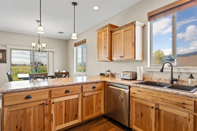 1317 Creekside Dr, Stevensville, MT 59870 - kitchen featuring stainless steel dishwasher, a sink, a peninsula, a chandelier, and dark wood-style floors