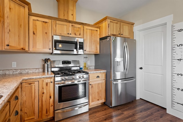 1317 Creekside Dr, Stevensville, MT 59870 - kitchen featuring appliances with stainless steel finishes, dark wood-style floors, light stone counters, and light brown cabinets