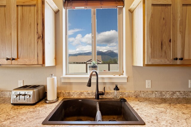 1317 Creekside Dr, Stevensville, MT 59870 - kitchen featuring a sink, a mountain view, light countertops, and light brown cabinetry