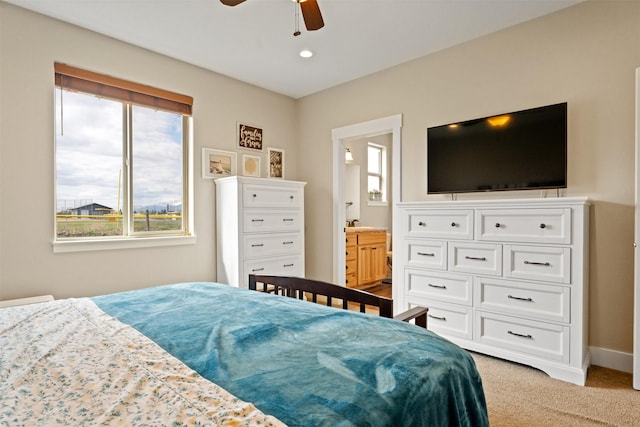 1317 Creekside Dr, Stevensville, MT 59870 - bedroom featuring light colored carpet, connected bathroom, baseboards, and a ceiling fan