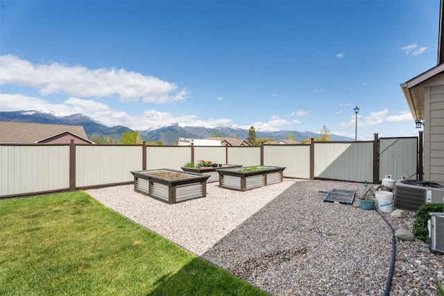 1317 Creekside Dr, Stevensville, MT 59870 - view of yard featuring a garden, a mountain view, and central AC unit