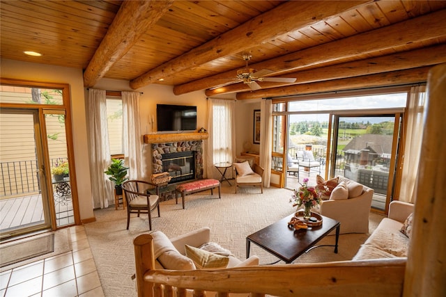 281 Eagle Bend Dr, Bigfork, MT 59911 - living room featuring plenty of natural light, a wooden ceiling with exposed beams, a stone fireplace, tile patterned flooring, and a ceiling fan