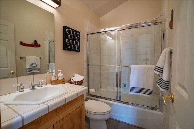 281 Eagle Bend Dr, Bigfork, MT 59911 - bathroom with vanity, lofted ceiling, and combined bath / shower with glass door