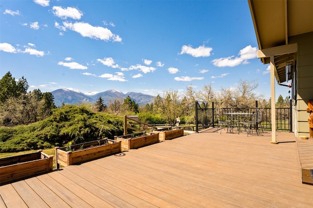 445 Sapphire Ln, Stevensville, MT 59870 - deck featuring a garden, outdoor dining space, and a mountain view