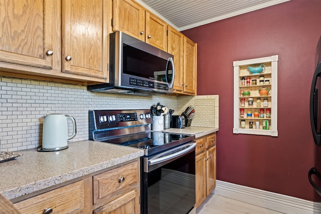 445 Sapphire Ln, Stevensville, MT 59870 - kitchen with appliances with stainless steel finishes, tasteful backsplash, brown cabinets, crown molding, and light stone counters