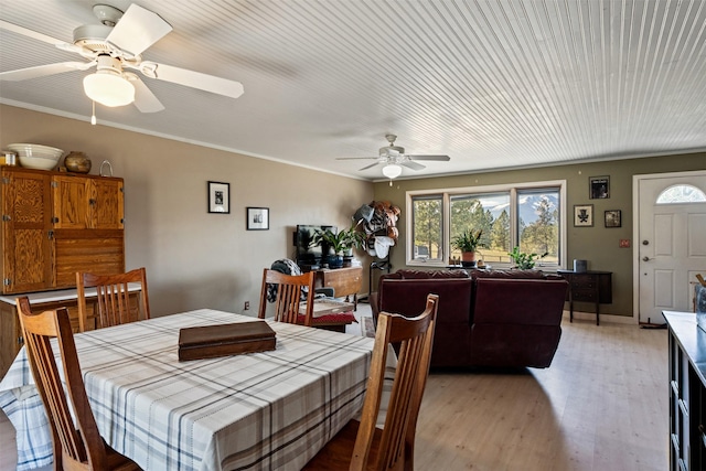 445 Sapphire Ln, Stevensville, MT 59870 - dining area featuring a ceiling fan, light wood-style floors, and crown molding
