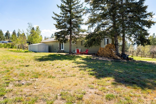 445 Sapphire Ln, Stevensville, MT 59870 - view of yard featuring a storage unit and entry steps