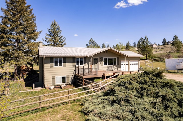 445 Sapphire Ln, Stevensville, MT 59870 - single story home with a garage, a chimney, a metal roof, and a deck