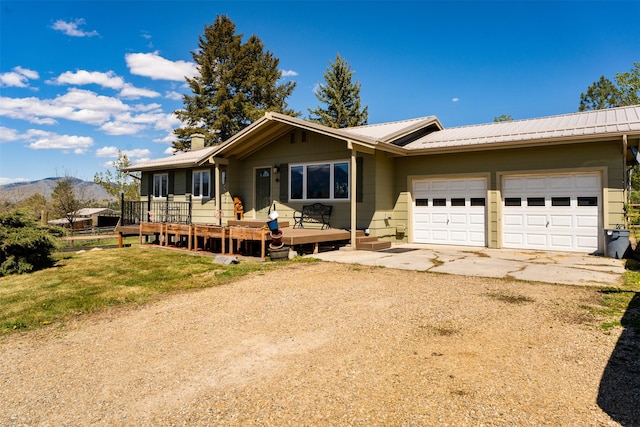 445 Sapphire Ln, Stevensville, MT 59870 - single story home featuring dirt driveway, a garage, a metal roof, and a deck with mountain view