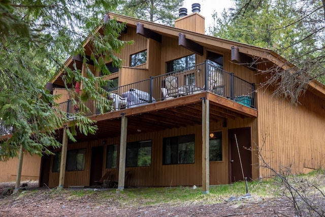 74 Limber Pne, Whitefish, MT 59937 - back of property with a chimney and a wooden deck