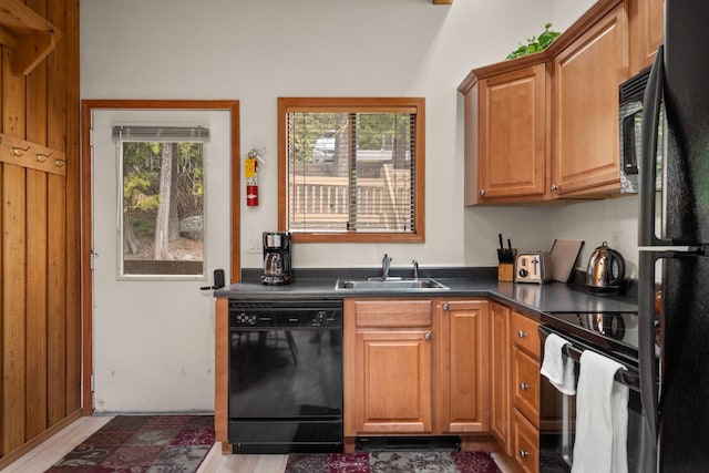 74 Limber Pne, Whitefish, MT 59937 - kitchen featuring black appliances, dark countertops, light wood finished floors, and brown cabinets