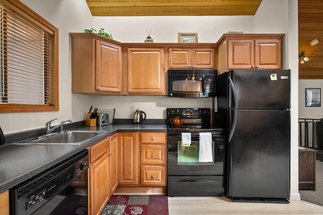 74 Limber Pne, Whitefish, MT 59937 - kitchen featuring black appliances, light wood-style flooring, dark countertops, and brown cabinetry