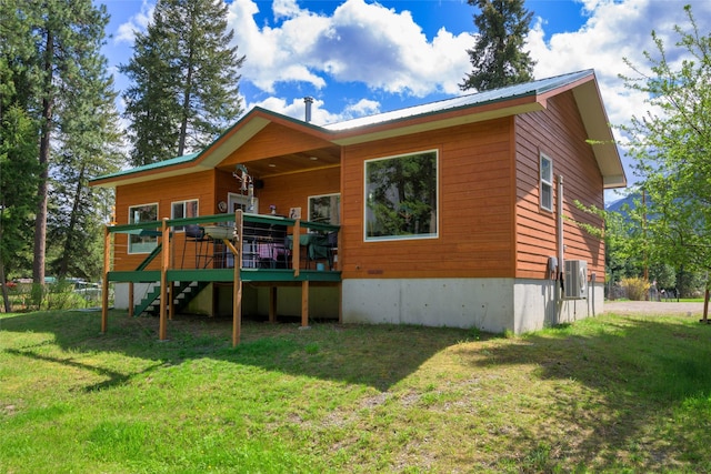 1500 River Rd W, Plains, MT 59859 - rear view of house featuring stairway, a lawn, metal roof, and a wooden deck