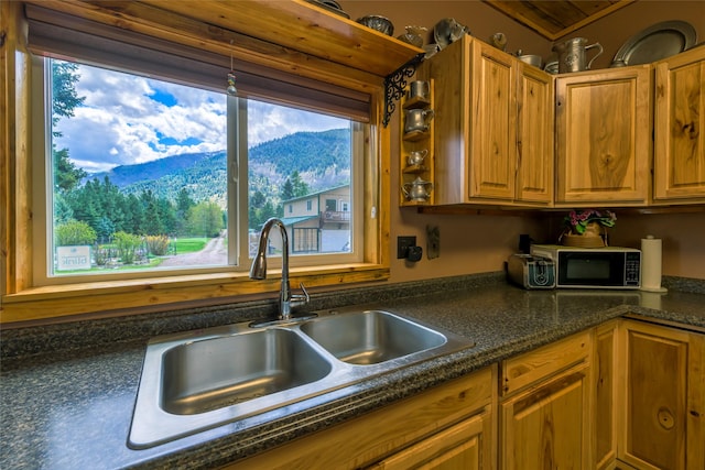 1500 River Rd W, Plains, MT 59859 - kitchen with a sink, a mountain view, brown cabinetry, and dark stone counters