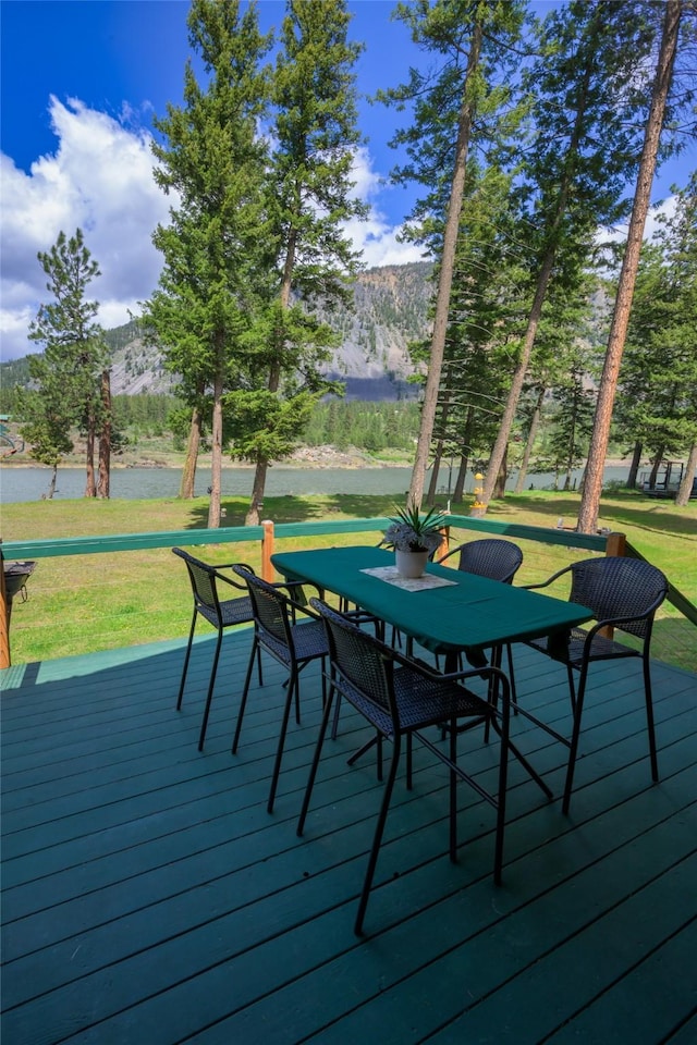 1500 River Rd W, Plains, MT 59859 - wooden terrace featuring a mountain view, a yard, and outdoor dining space